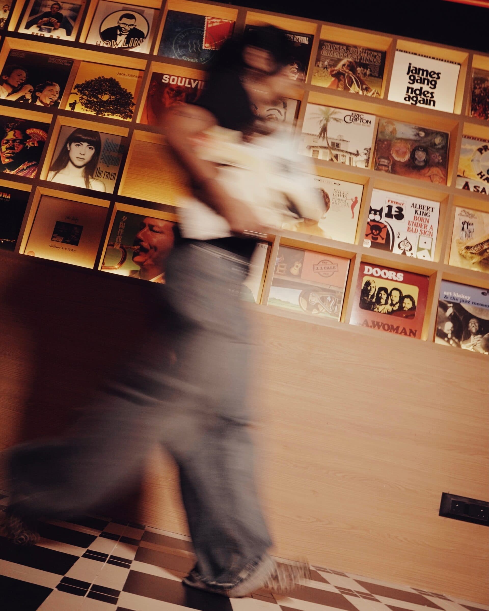 A guest dancing past the record wall